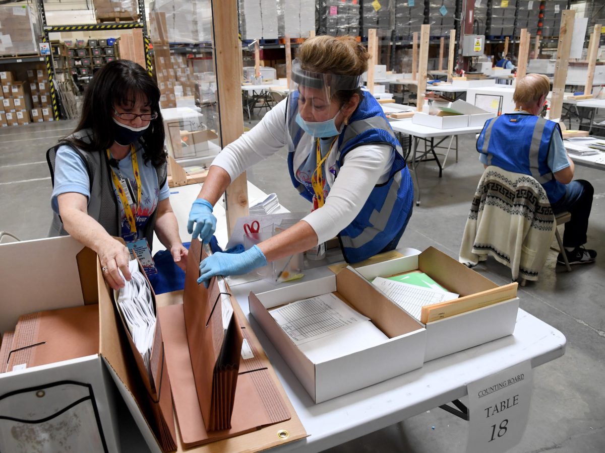 Ann-Marie Gomes (L) and Juanita Thompson count and verify mail ballots at the Clark County Election Department, which is serving as both a primary election ballot drop-off point and an in-person voting center amid the coronavirus pandemic on June 9, 2020 in North Las Vegas, Nevada. This is the first time ballots have been mailed to all registered active voters in Nevada's history as the state holds its first-ever election done almost entirely by mail due to the risk of spreading COVID-19. The Clark County registrar said unofficial results of the election will be reported tonight but, final results will not be available until after the last ballots are counted on June 16 or 17. (Photo by Ethan Miller/Getty Images)